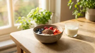 Frühstücksschale mit Joghurt, Beeren und Haferflocken auf einem Küchentisch
